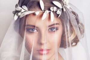 bridal hair accessory tips - Natural gum leaf headband holding veil in place.