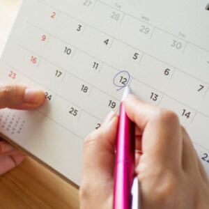 2021 Wedding Trends - Woman marking a mid-week wedding date in her calendar.